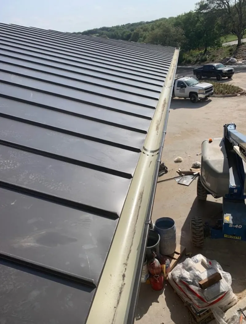 Standing seam panel and gutter detail on a metal roofing jobsite in Northfield